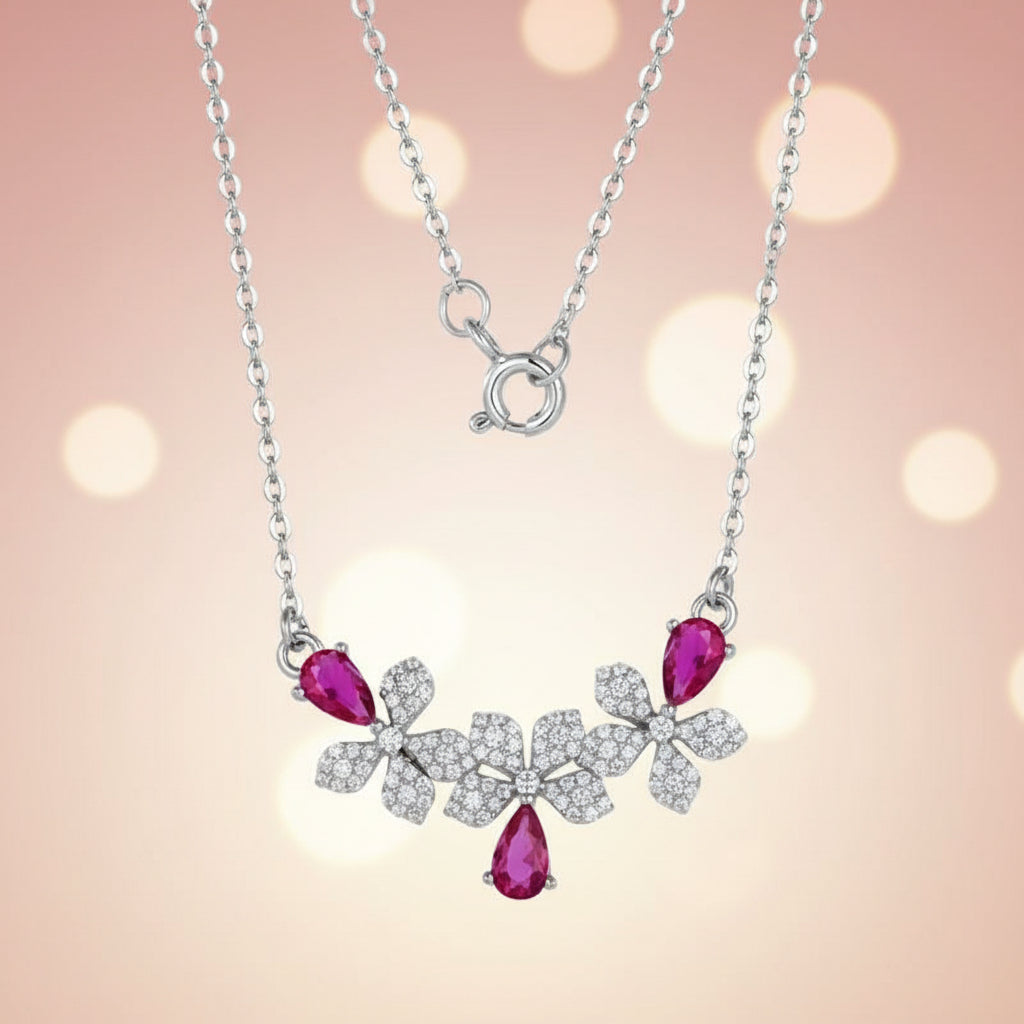 Necklace with pink gemstones and silver floral design